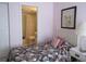 Bedroom with twin bed, en-suite bathroom, and floral bedding at 4546 Longwater # 44, Sarasota, FL 34235