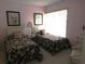 Two twin beds with floral bedding in a bright bedroom at 4546 Longwater # 44, Sarasota, FL 34235