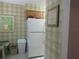 Kitchen features white appliances and a checkered wall at 4546 Longwater # 44, Sarasota, FL 34235
