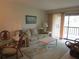 Comfortable living room with neutral color palette and patio access at 4546 Longwater # 44, Sarasota, FL 34235
