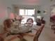 Charming dining area with glass-top table and wicker chairs at 4546 Longwater # 44, Sarasota, FL 34235