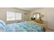Main bedroom with a double bed, dresser with a mirror, and a window at 475 Benjamin Franklin Dr # 209, Sarasota, FL 34236