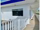 Exterior view showing a hallway with white walls and railings, a window, and palm trees at 475 Benjamin Franklin Dr # 209, Sarasota, FL 34236