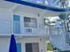 Building exterior featuring a spiral staircase and private balconies at 475 Benjamin Franklin Dr # 209, Sarasota, FL 34236