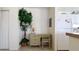 Small home office area with a desk, chair, and a tall plant at 475 Benjamin Franklin Dr # 209, Sarasota, FL 34236