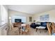 Living room with a sectional sofa, round table, and TV at 475 Benjamin Franklin Dr # 209, Sarasota, FL 34236