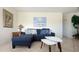 Living room featuring a sectional sofa, two small white tables, and coastal decor at 475 Benjamin Franklin Dr # 209, Sarasota, FL 34236