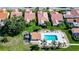 Aerial view of backyard featuring a pool, landscaping, patio area and terra cotta roofs at 4872 Limetree Ln, Venice, FL 34293
