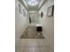 Long hallway with tile floors and neutral wall colors at 5211 Moon Shell Dr, Apollo Beach, FL 33572