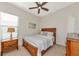 Bedroom with wooden furniture and striped bedding at 5238 Napoli Run, Bradenton, FL 34211