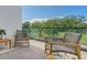 Private balcony with outdoor seating and green space views at 62 Audubon Pl, Sarasota, FL 34237
