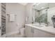 Modern bathroom with marble tile, vanity, and updated fixtures at 62 Audubon Pl, Sarasota, FL 34237