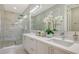 Modern bathroom with double vanity and marble shower at 62 Audubon Pl, Sarasota, FL 34237