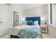Cozy bedroom with blue headboard and ensuite access at 62 Audubon Pl, Sarasota, FL 34237