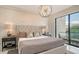 Spacious bedroom with plush bedding and large window at 62 Audubon Pl, Sarasota, FL 34237