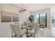 Bright dining area with glass table and modern chairs at 62 Audubon Pl, Sarasota, FL 34237
