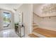 Bright entryway with marble floors, a staircase, and console table at 62 Audubon Pl, Sarasota, FL 34237