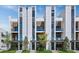 Modern three-story townhouses with balconies and landscaped yards at 62 Audubon Pl, Sarasota, FL 34237