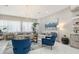 Spacious living room with light beige couches and blue armchairs at 62 Audubon Pl, Sarasota, FL 34237