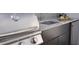 Stainless steel outdoor kitchen with granite countertops and grill at 62 Audubon Pl, Sarasota, FL 34237