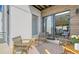 Relaxing patio with wicker chairs and access to interior at 62 Audubon Pl, Sarasota, FL 34237