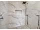 Spa-like shower with marble tile and rainfall showerhead at 62 Audubon Pl, Sarasota, FL 34237