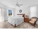 Bright bedroom with king-size bed, tiled floors, and access to a patio at 6828 Coyote Ridge Ct, University Park, FL 34201