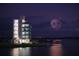 Modern lakeside building with fireworks display at 6828 Coyote Ridge Ct, University Park, FL 34201