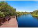 Serene waterfront dock with a bench, perfect for relaxing at 6828 Coyote Ridge Ct, University Park, FL 34201