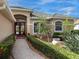 Inviting front entry with brick walkway and lush landscaping at 6828 Coyote Ridge Ct, University Park, FL 34201