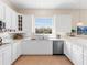 White kitchen with stainless steel appliances and subway tile backsplash at 6828 Coyote Ridge Ct, University Park, FL 34201
