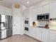 Modern kitchen with stainless steel appliances and white cabinetry at 6828 Coyote Ridge Ct, University Park, FL 34201