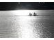 Two people rowing a boat on a lake at sunset at 6828 Coyote Ridge Ct, University Park, FL 34201
