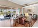Spacious living room with hardwood floors, fireplace, and pool view at 6828 Coyote Ridge Ct, University Park, FL 34201