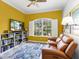 Home office with built in shelving, comfortable seating, and large window at 6828 Coyote Ridge Ct, University Park, FL 34201