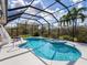 Resort-style pool and spa with screened enclosure and lush landscaping at 6828 Coyote Ridge Ct, University Park, FL 34201
