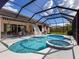 Inviting pool and spa area with a screened enclosure at 6828 Coyote Ridge Ct, University Park, FL 34201