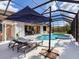 Screened pool and spa with lounge chairs and patio furniture at 6828 Coyote Ridge Ct, University Park, FL 34201