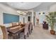 Formal dining room with wood table, six chairs, and modern light fixture at 8231 Stirling Falls Cir, Sarasota, FL 34243