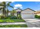 House exterior with a two-car garage and well-maintained landscaping at 8231 Stirling Falls Cir, Sarasota, FL 34243