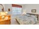 Guest bedroom with floral bedding and wooden dresser at 8231 Stirling Falls Cir, Sarasota, FL 34243