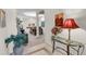 Bright entryway with glass-top table, lamp, and potted plant at 8231 Stirling Falls Cir, Sarasota, FL 34243