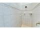 Clean shower with tile surround and single shower head at 8231 Stirling Falls Cir, Sarasota, FL 34243
