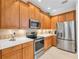 Well-equipped kitchen with stainless steel appliances and wood cabinets at 8231 Stirling Falls Cir, Sarasota, FL 34243