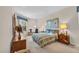 Spacious bedroom with king-size bed, wood dresser, and large window at 8231 Stirling Falls Cir, Sarasota, FL 34243