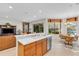 Kitchen with light wood cabinets, stainless steel appliances and breakfast bar at 8231 Stirling Falls Cir, Sarasota, FL 34243