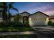 Inviting single-story home with a two-car garage and lush landscaping at 8231 Stirling Falls Cir, Sarasota, FL 34243