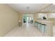 Virtually staged kitchen with light cabinets and teal stools at 101 Gull Dr, Anna Maria, FL 34216