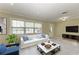 Virtually staged living room with a white couch and blue accent chair at 101 Gull Dr, Anna Maria, FL 34216