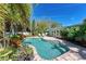 Inviting freeform pool surrounded by lush landscaping at 101 Gull Dr, Anna Maria, FL 34216